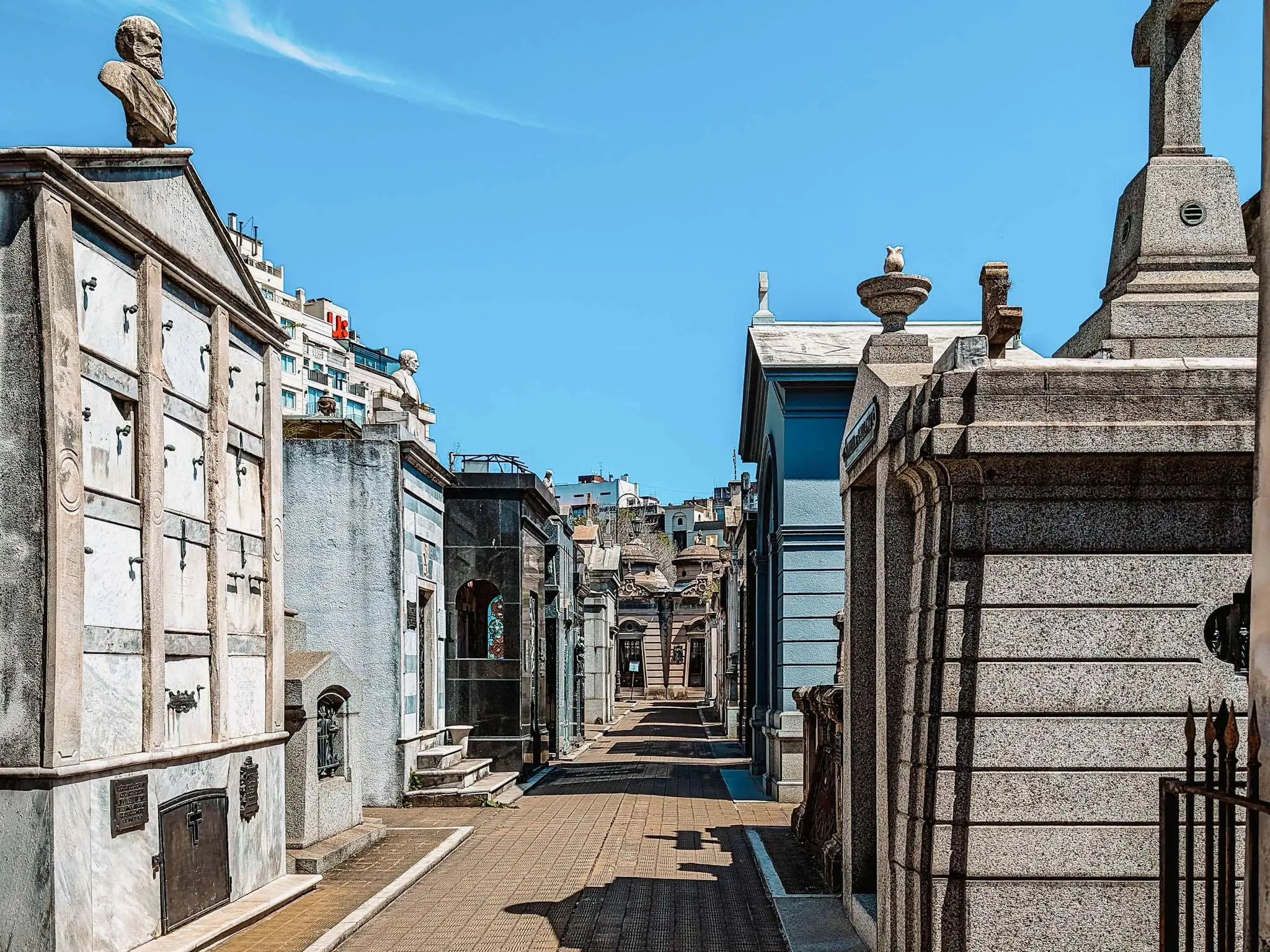 An aisle through large crypts in a cemetery - free buenos aires walking tours