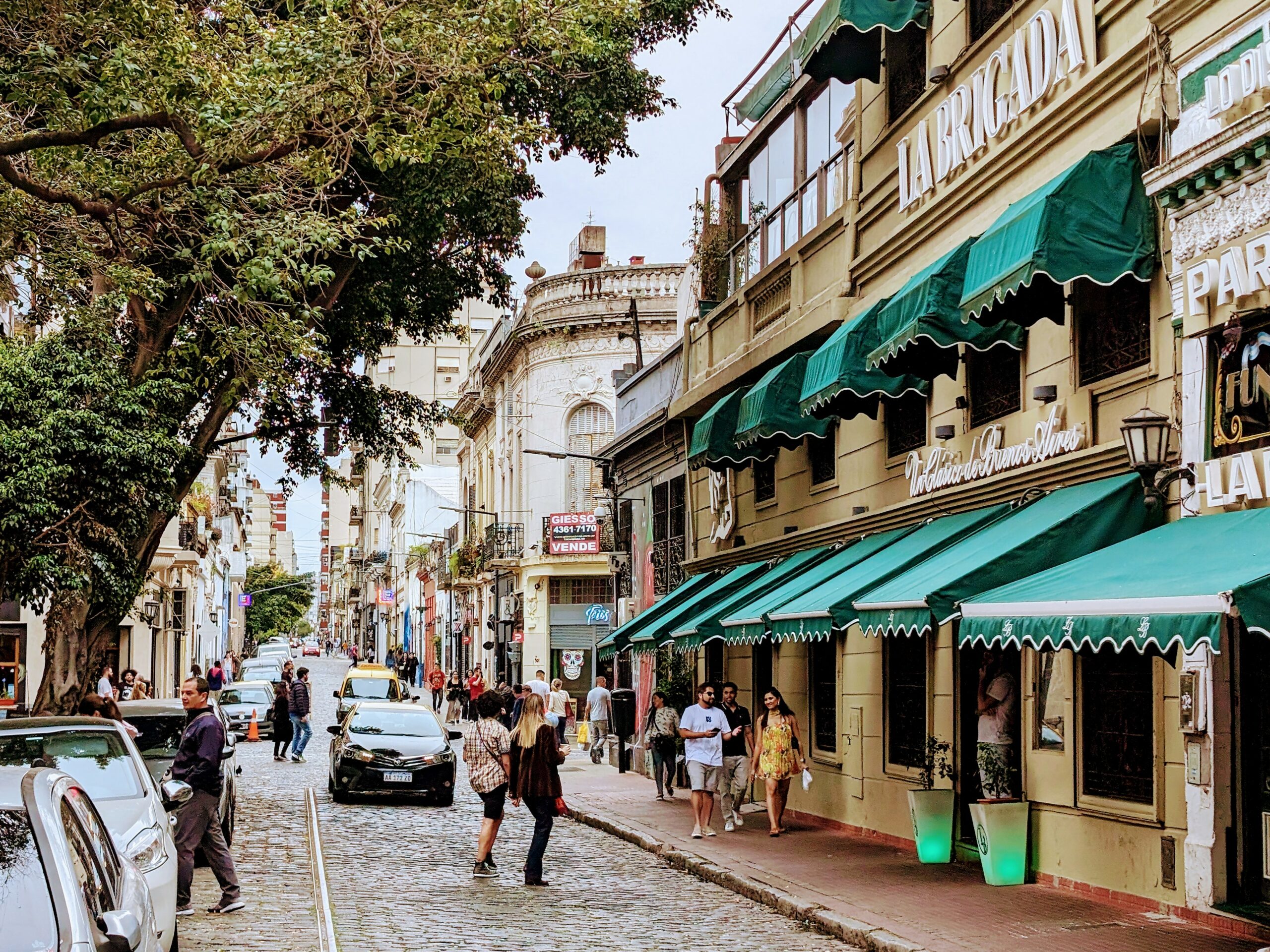 Street in San Telmo, Buenos Aires, Argentina with shops with green awnings.