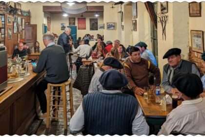 A bustling restaurant filled with people seated at tables, enjoying good company and delicious meals in San Antonio de Areco