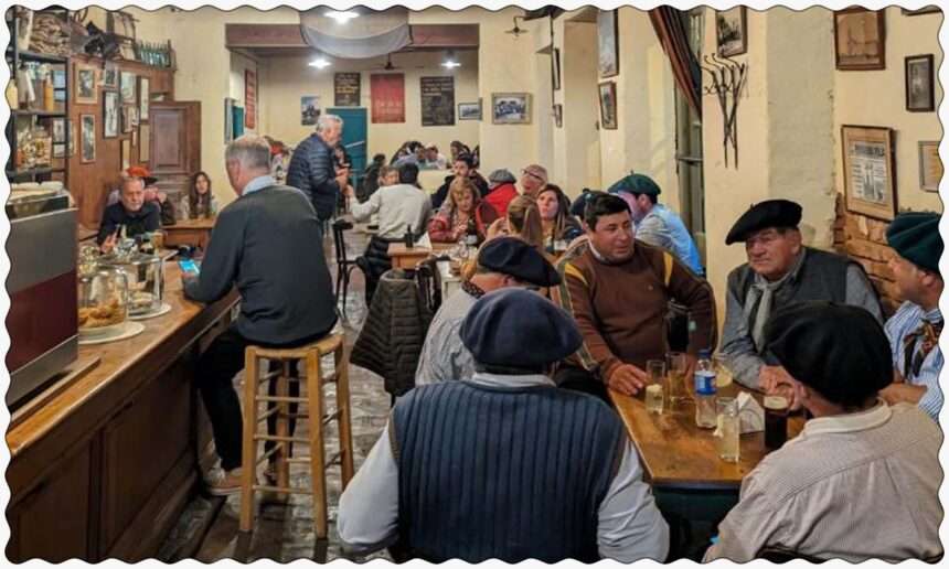 A bustling restaurant filled with people seated at tables, enjoying good company and delicious meals in San Antonio de Areco