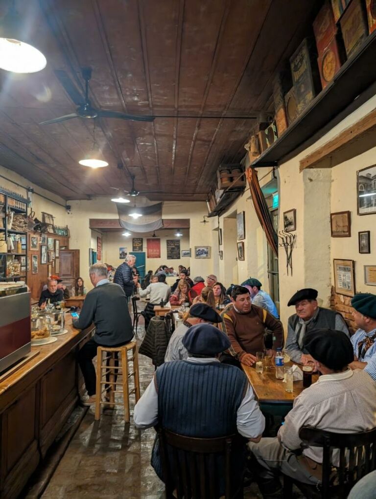 A bustling restaurant filled with people seated at tables, enjoying good company and delicious meals.