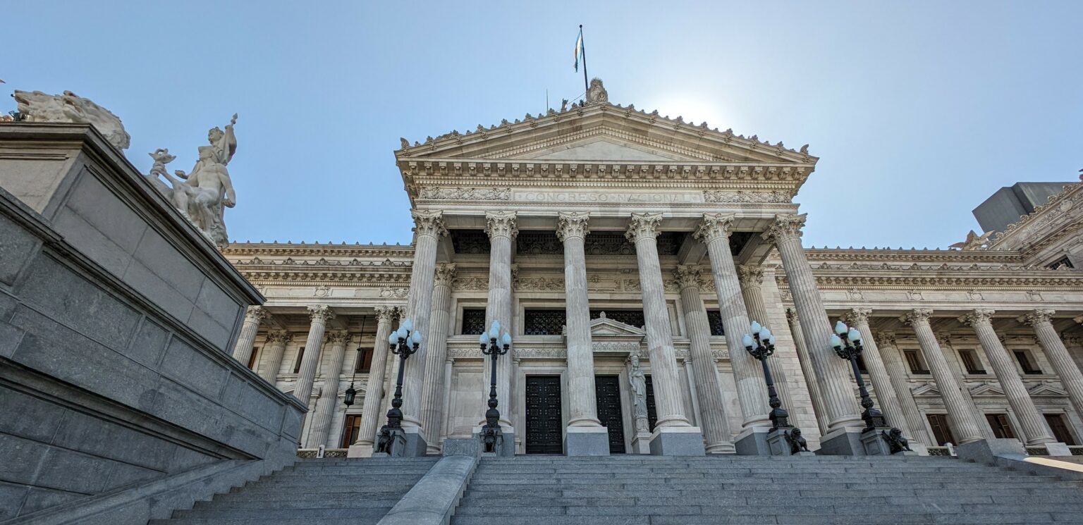 Upward angle of the Congress building in Buenos Aires with a blue sky.