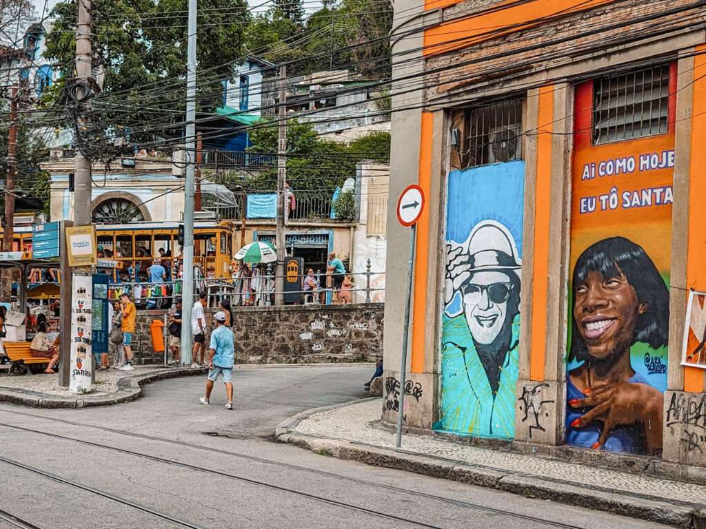 A street with tram lines going through it and buildings with street art - Things to do in Rio de Janeiro