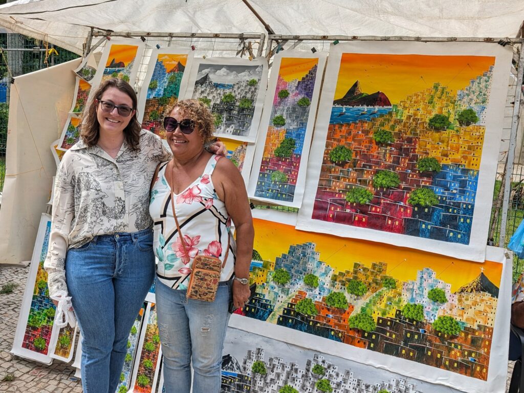 Two people standing in front of an artists work of art in Rio de Janeiro