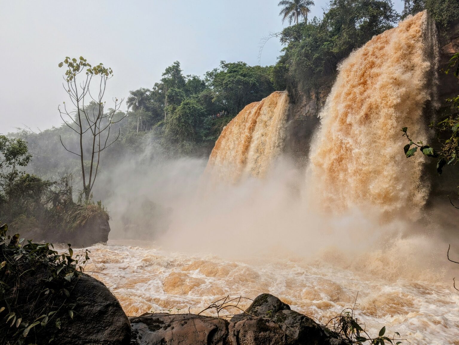 two orange waterfalls in a jungle - Iguazu Falls itinerary