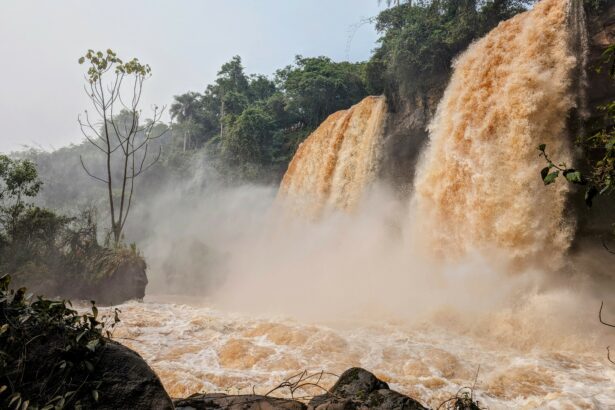 two orange waterfalls in a jungle - Iguazu Falls itinerary