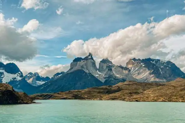 Granite peaks of Torres del Paine behind turquoise water in Chilean Patagonia