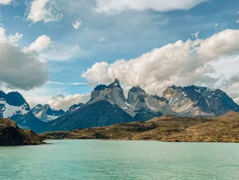 Granite peaks of Torres del Paine behind turquoise water in Chilean Patagonia