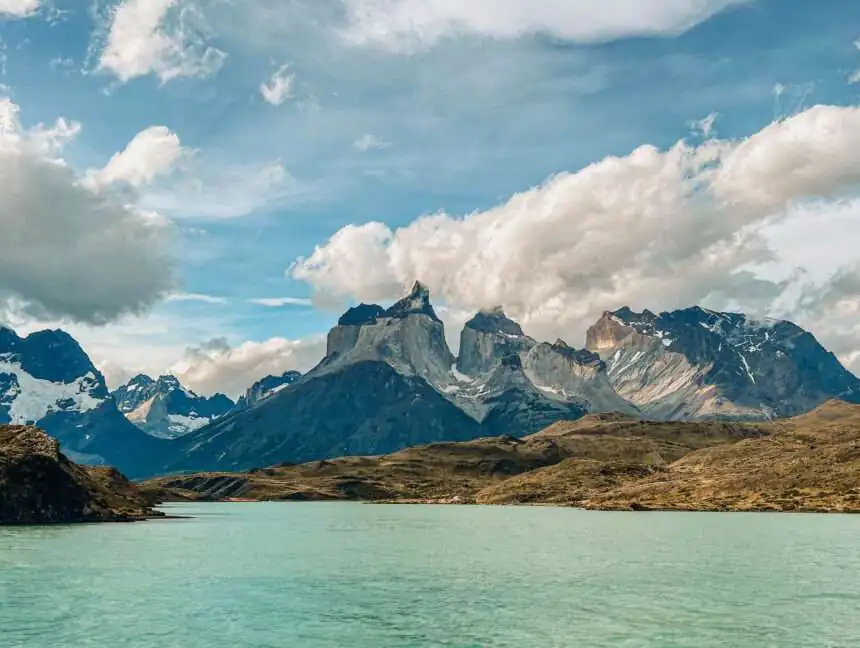 Granite peaks of Torres del Paine behind turquoise water in Chilean Patagonia
