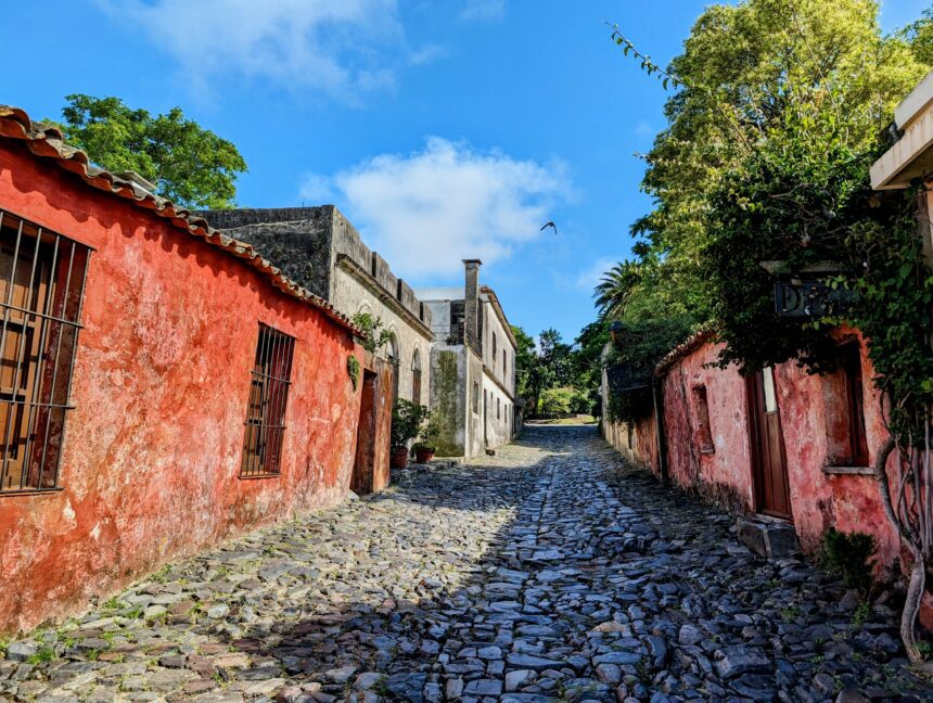 An old historic street in a former Spanish colony with cobblestone streets and red painted homes - Colonia del Sacramento