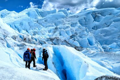 Three people captivated by the beauty of a massive glacier outside of El Calafate - what to do in el calafate - traveling to Patagonia