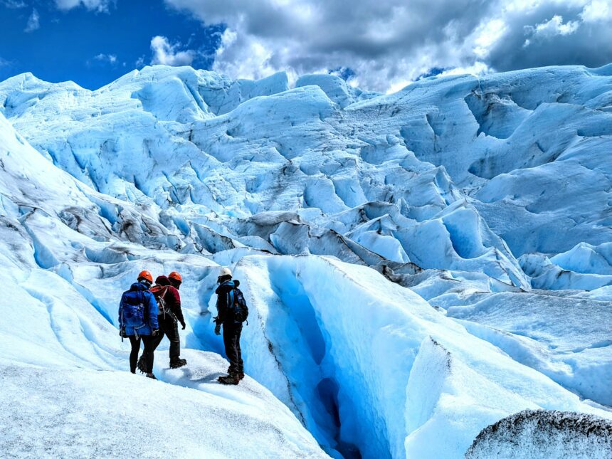 Three people captivated by the beauty of a massive glacier outside of El Calafate - what to do in el calafate - traveling to Patagonia