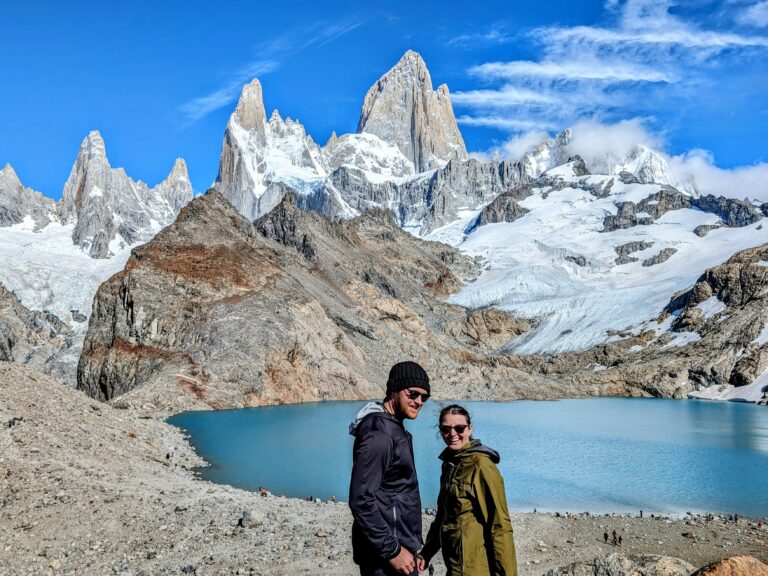 Two people enjoying the serene beauty of a mountain lake in El Chalten - What to do in El Chalten - Hikes in El Chalten