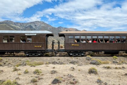 Two train cars sitting on a desert landscape - Esquel, Argentina