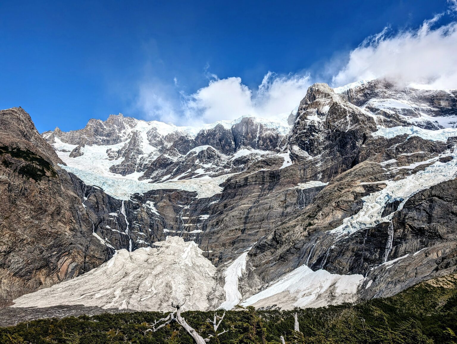Snow and glaciers on top of a rocky mountain - things to do in Torres del Paine
