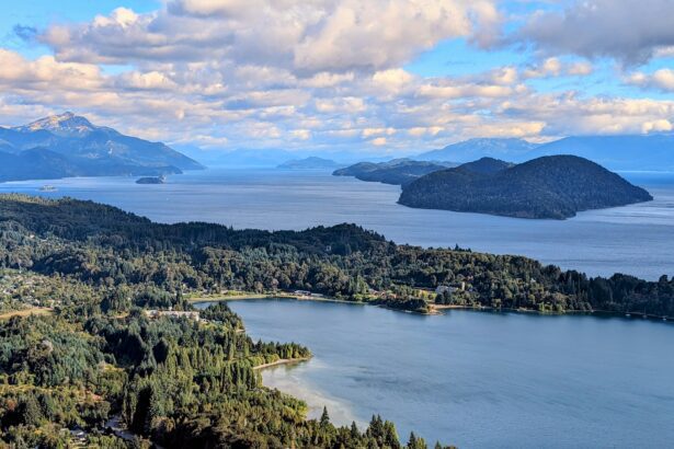 The view of a lake surrounded by forested mountains - Circuito Chico