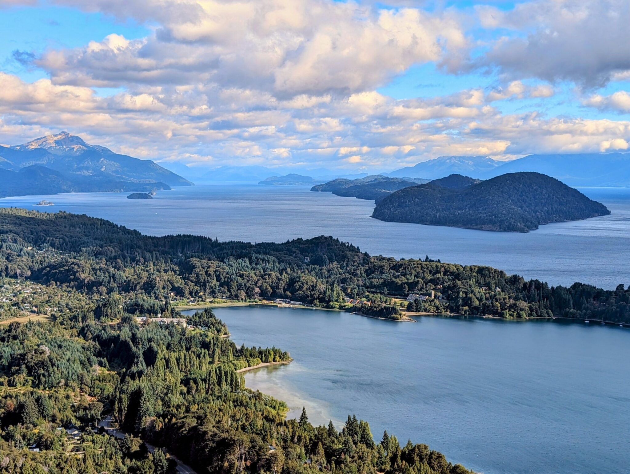 The view of a lake surrounded by forested mountains - Circuito Chico