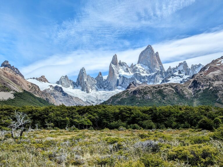 the serene beauty of mountain peaks coming out of a forest - What to do in El Chalten - traveling to Patagonia