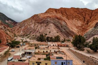 A colorful mountain over a colorful town that can be seen when visiting Salta