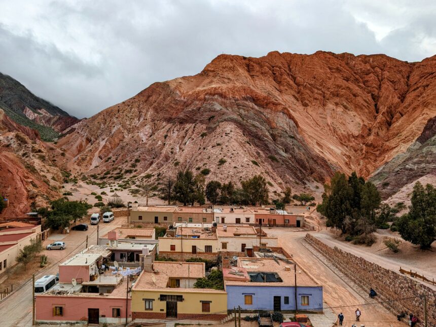 A colorful mountain over a colorful town that can be seen when visiting Salta