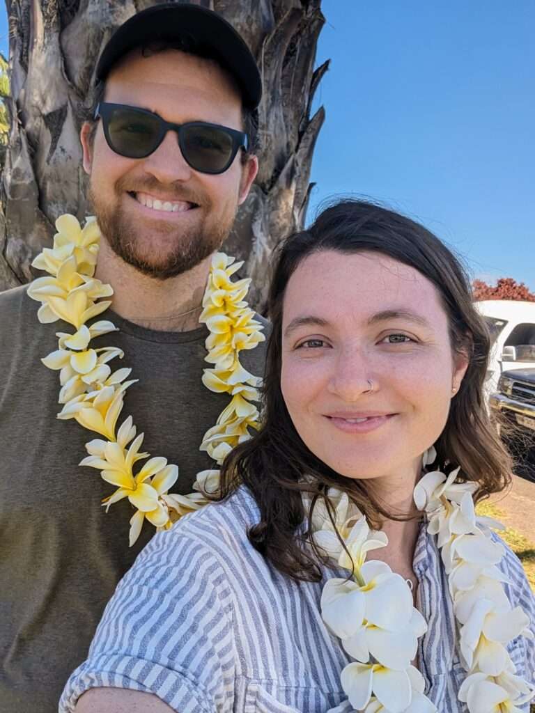 Two people taking a selfie wearing leis - Easter Island itinerary