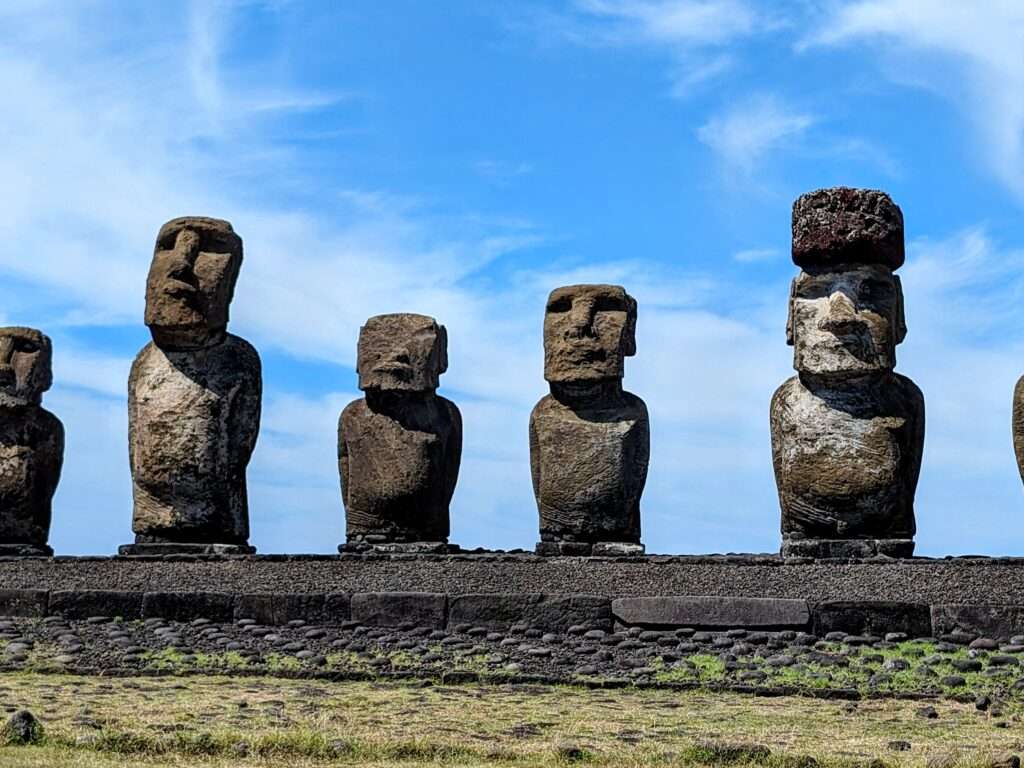 A set of statues on a stone platform - How to visit Easter Island