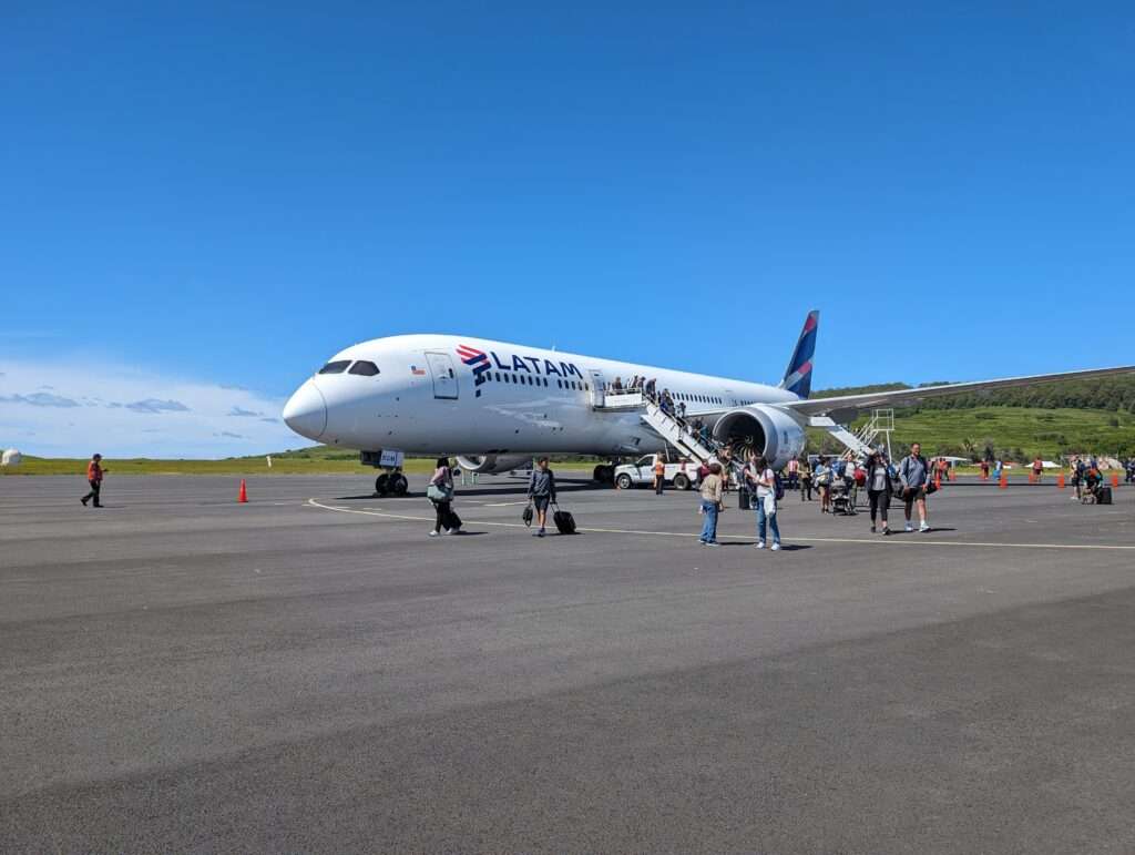People getting off a plane and walking on the tarmac - how to visit easter island