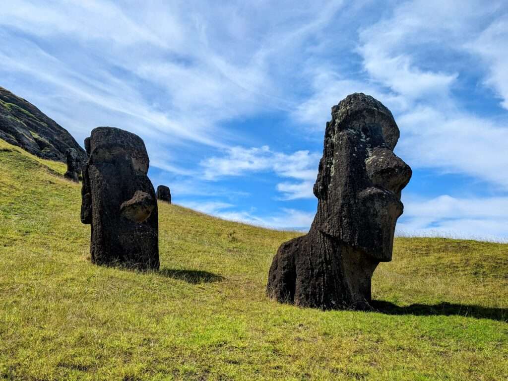 Two enormous head statues on a hill - How to Visit Easter Island