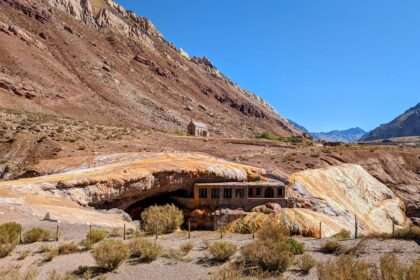 A building tucked under an orange and red rocky mountain - Things to do in Mendoza