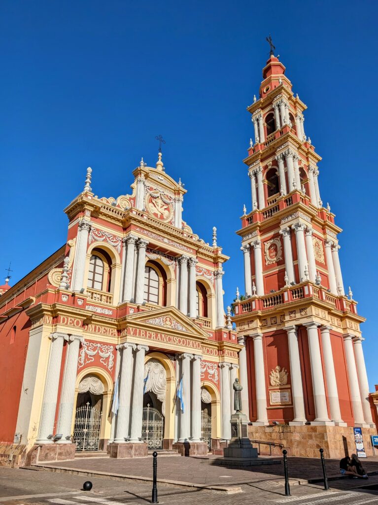A red and yellow cathedral in the center of Salta that can be seen when visiting Salta