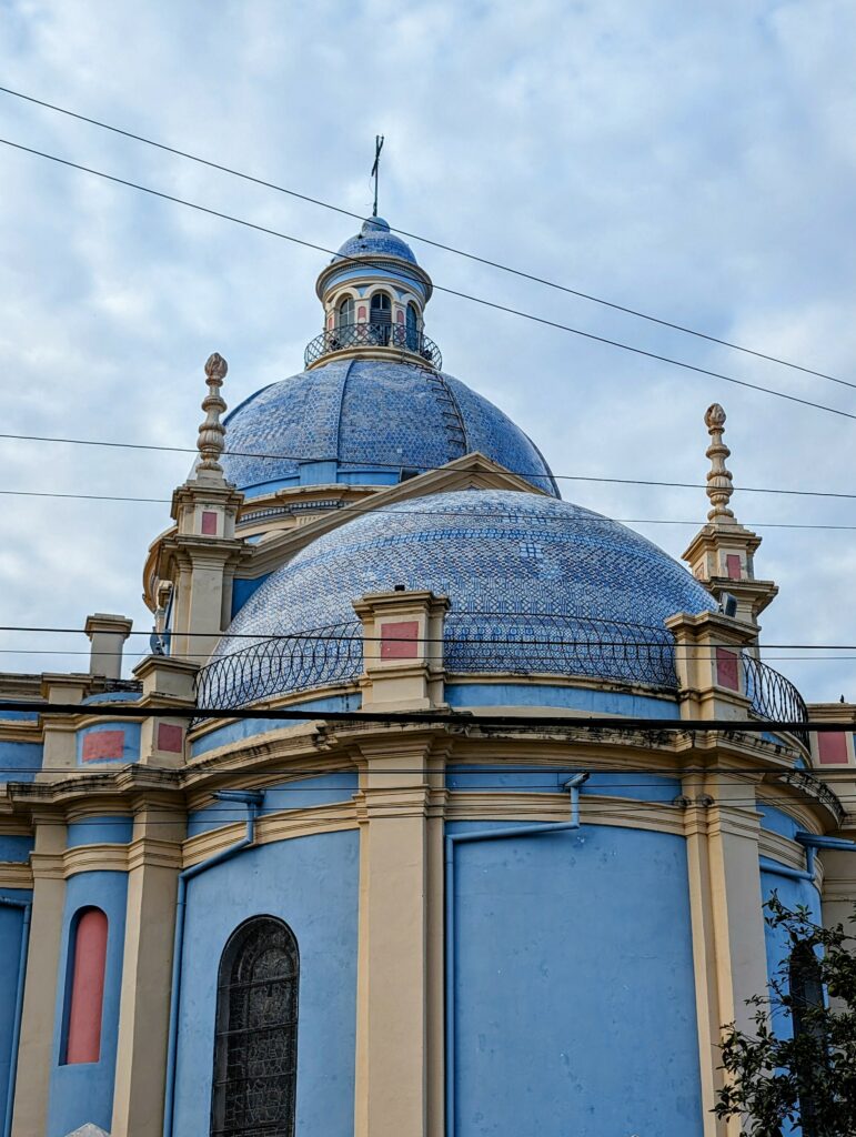A blue and yellow cathedral in the center of Salta that can be seen when visiting Salta