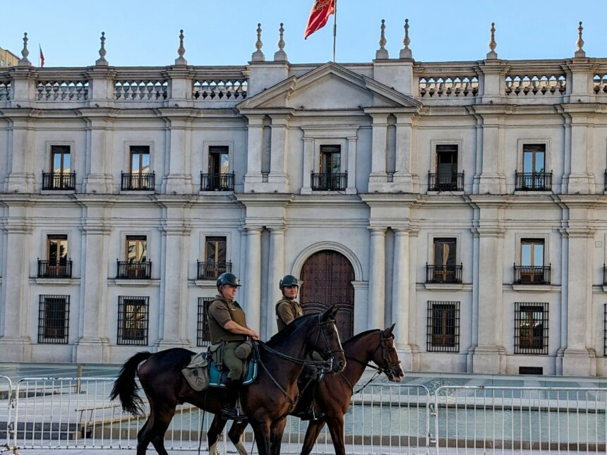 Two people on horses in front of a white government palace - Things to do in Santiago