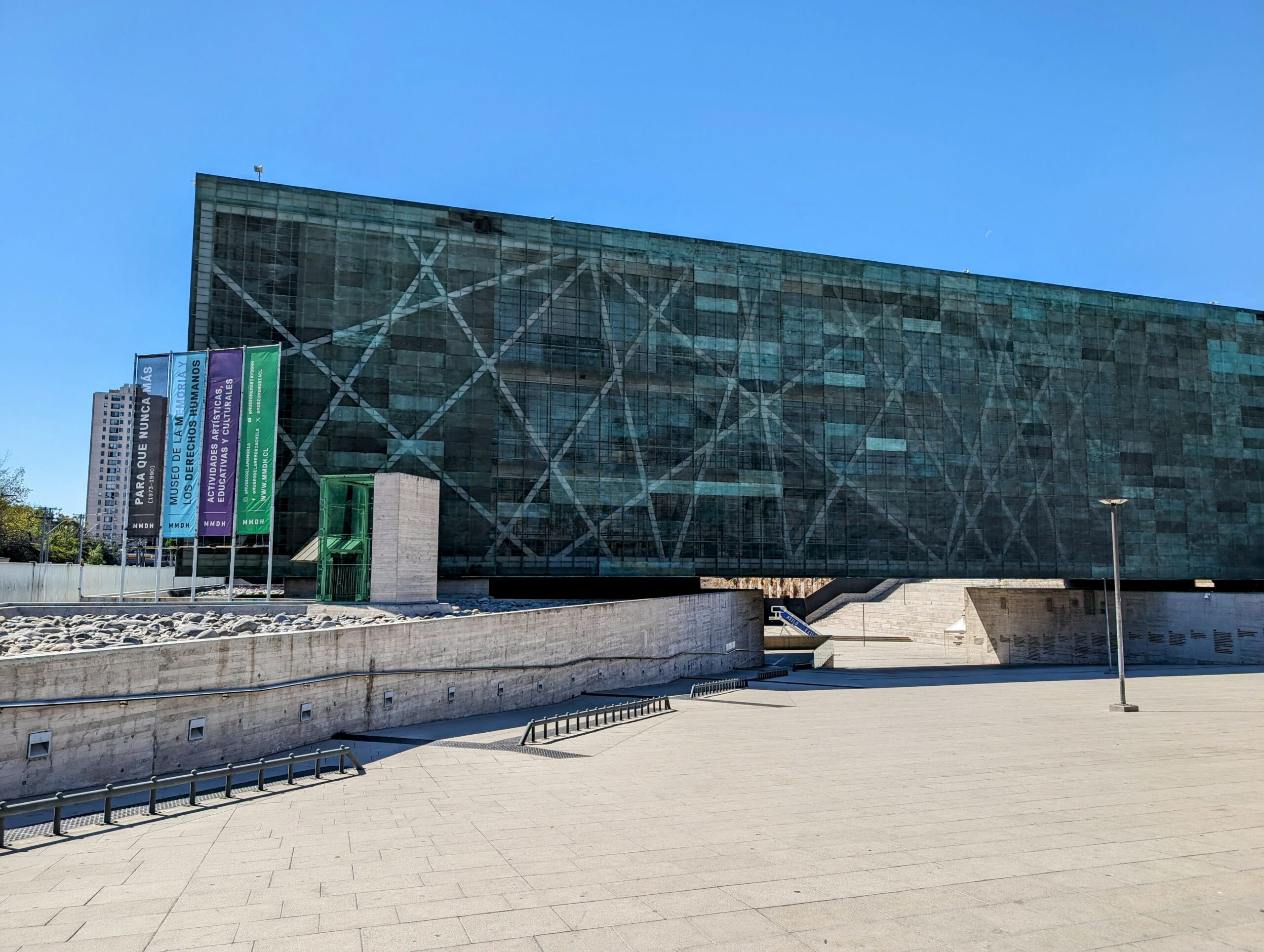 The exterior of a museum constructed with concrete and teal metal - Things to do in Santiago