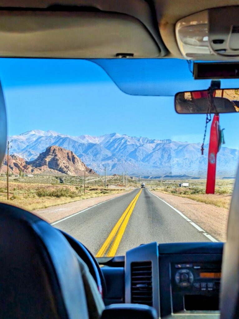 The interior of a car driving through the mountains where you may need travel insurance