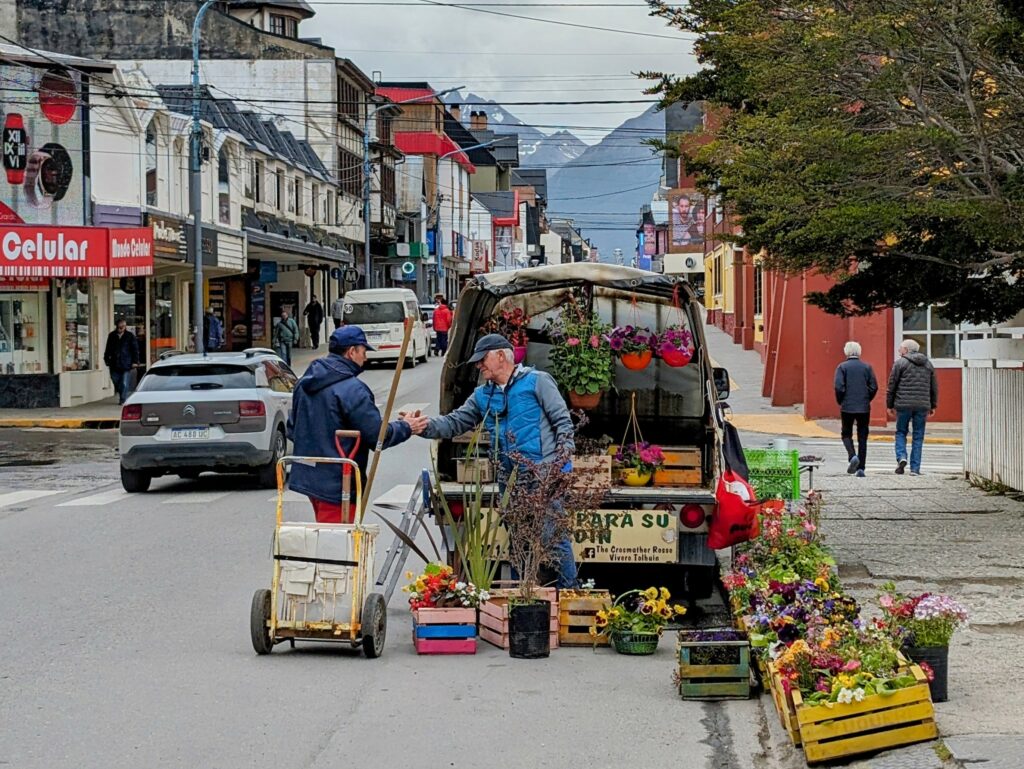 A flower vendor selling out of his car in Ushuaia where you may need travel insurance