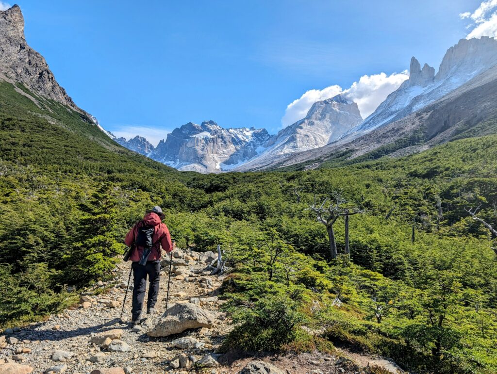 A man hiking through the mountains of Torres del Paine in Patagonia where you may need travel insurance