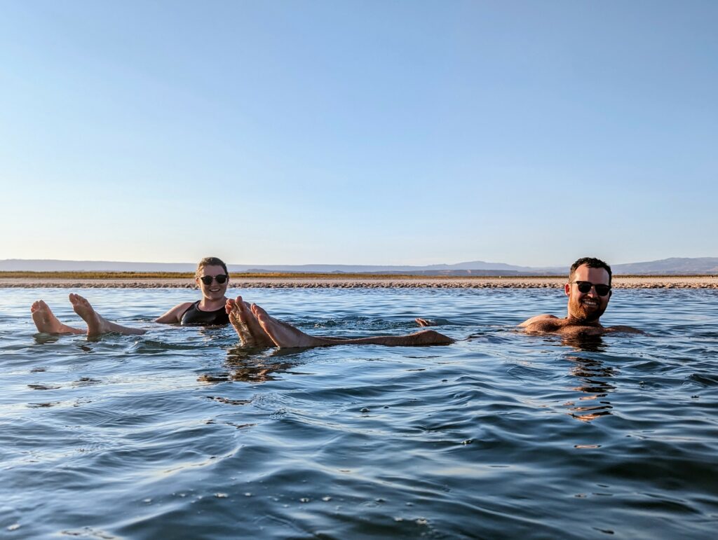 Two people floating in a salt lagoon outside of San Pedro de Atacama