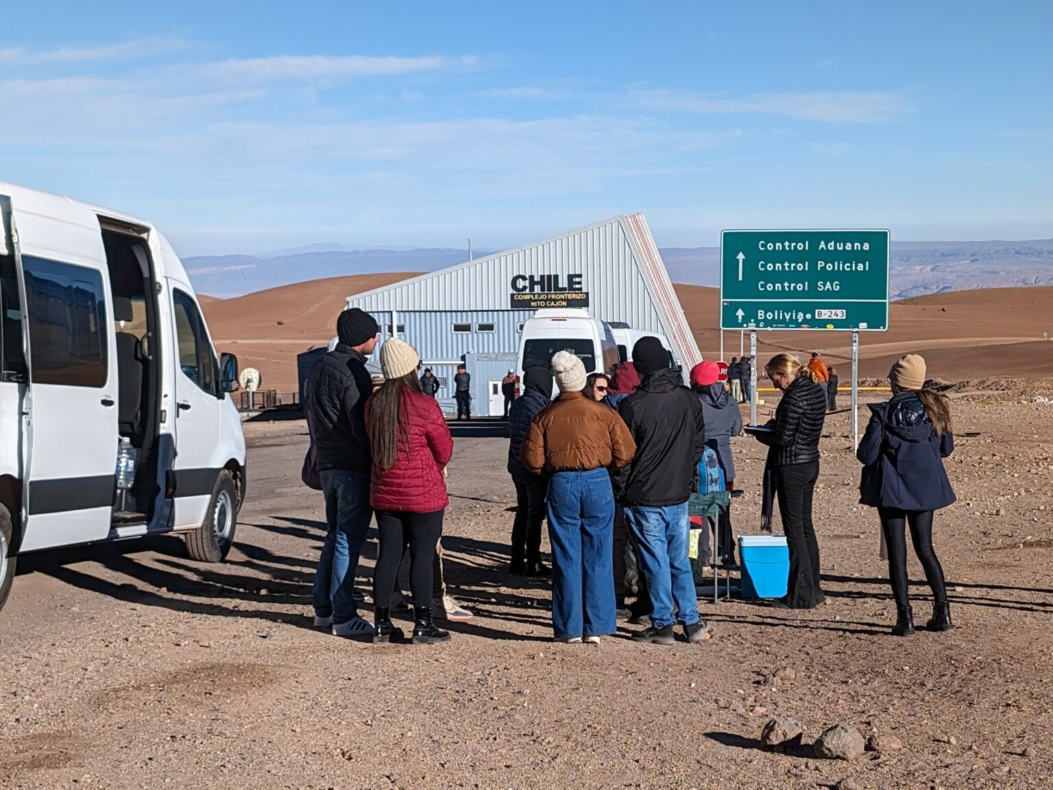 People waiting in line to cross a border and get a travel visa