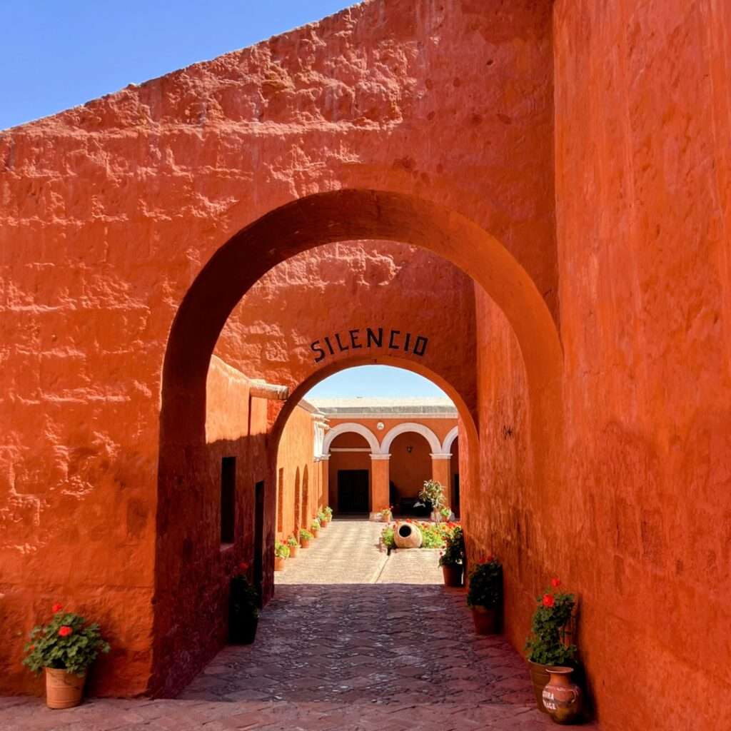 The orange walls and archways of a monastery in Arequipa