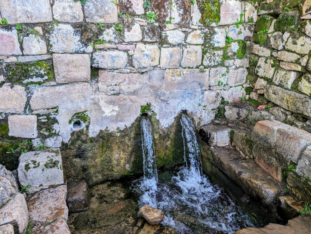 A fountain with two spouts of water on an island on Lake Titicaca
