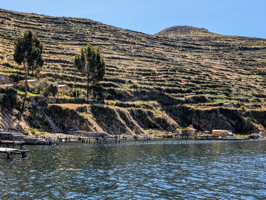 Terraces located on the side of a lake - things to do at Lake Titicaca