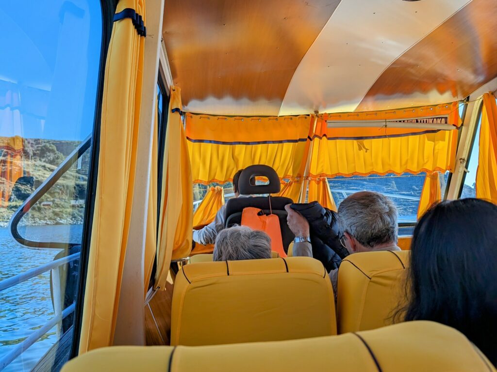 The yellow interior of a boat during a ride for a Lake Titicaca homestay