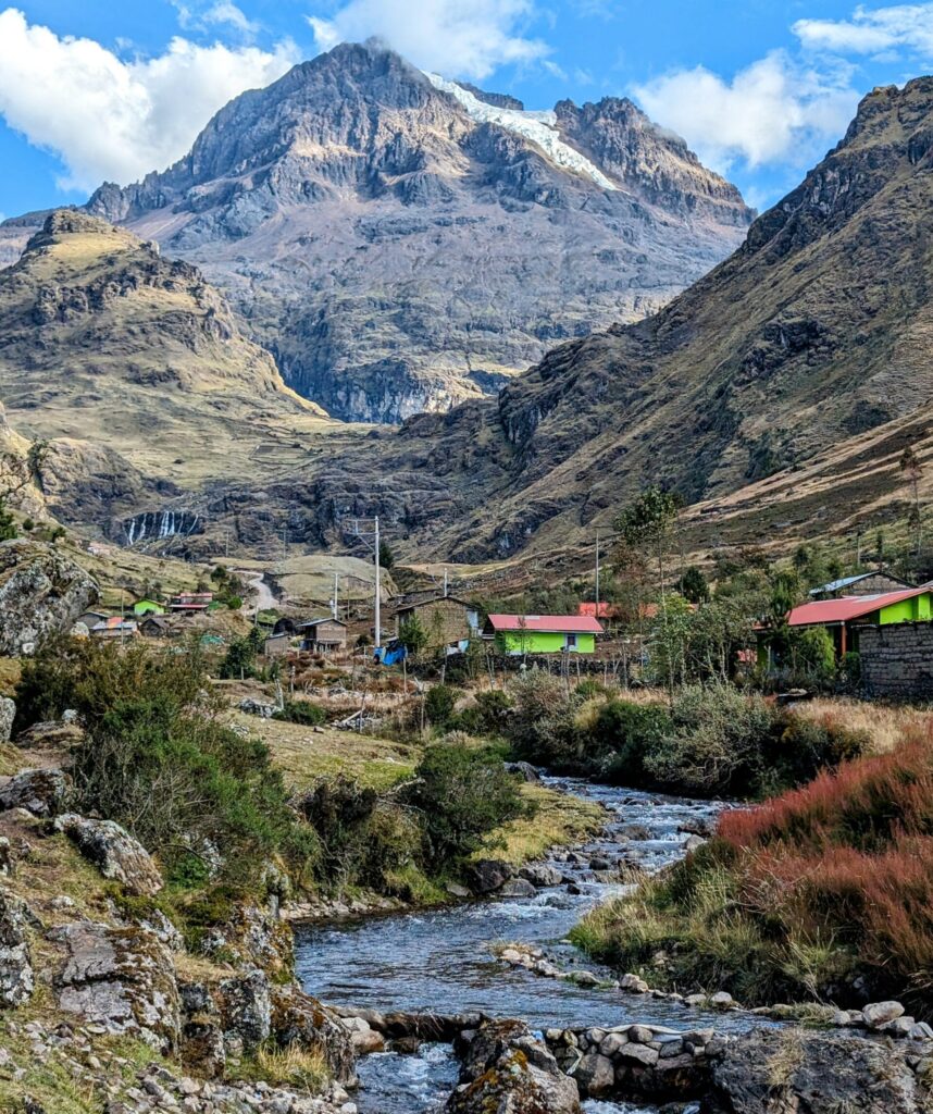 A river flowing between mountains and indigenous communities as part of the Lares Trek with one of the best inca trail tour operators