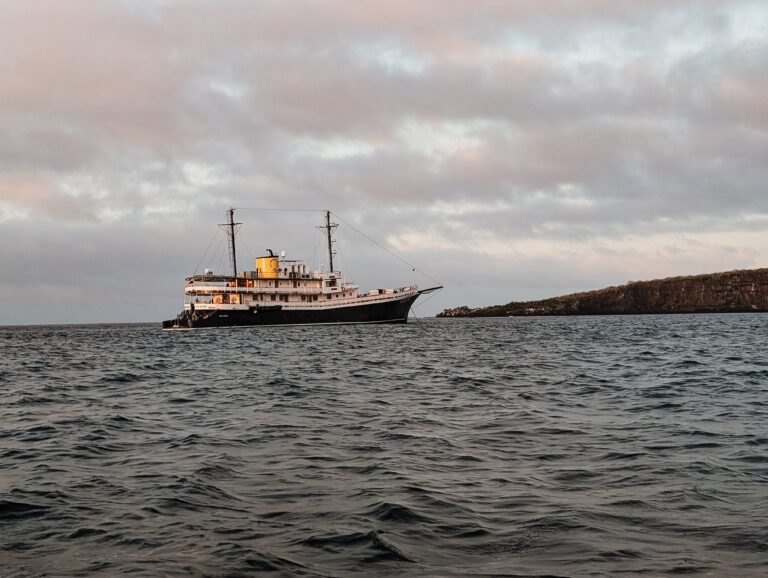The Quasar Expeditions yacht cruise anchored in a bay of the Galapagos islands