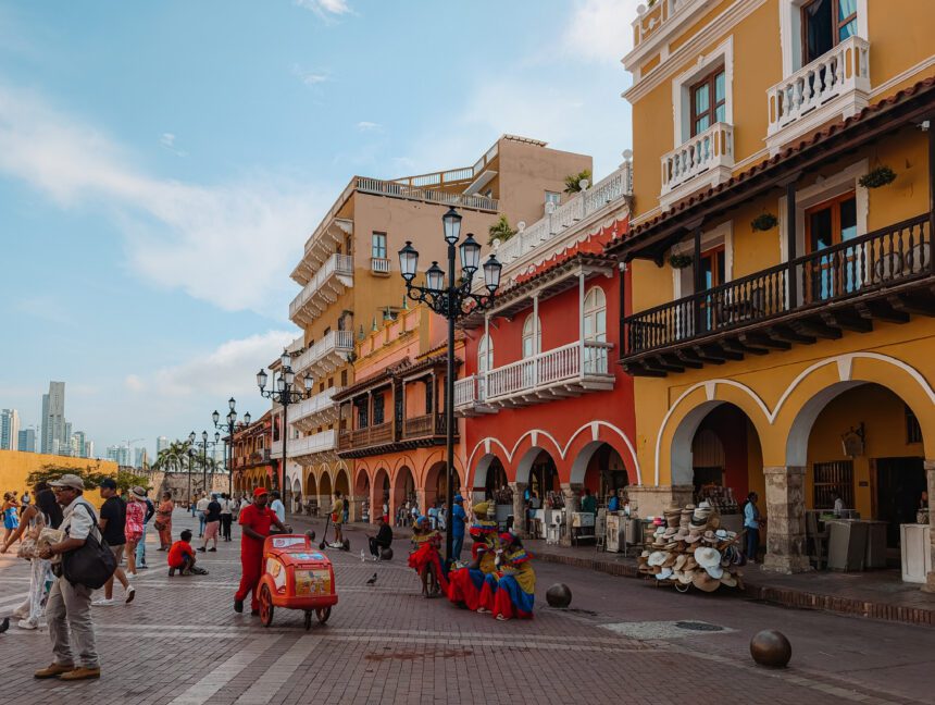 The main square at the entrance of the walled city of Cartagena with colorful buildings and local vendors - things to do in Cartagena