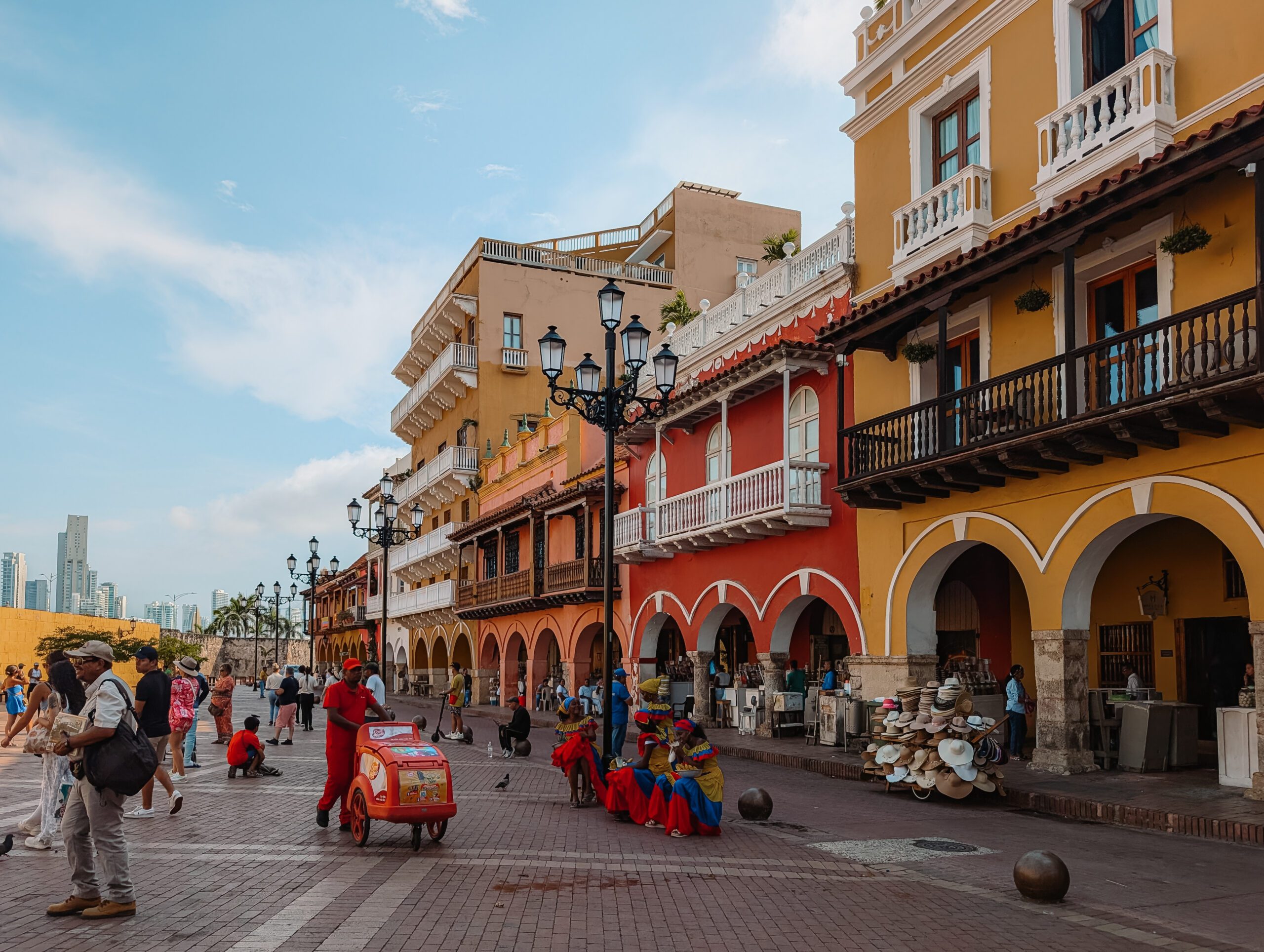 The main square at the entrance of the walled city of Cartagena with colorful buildings and local vendors - things to do in Cartagena