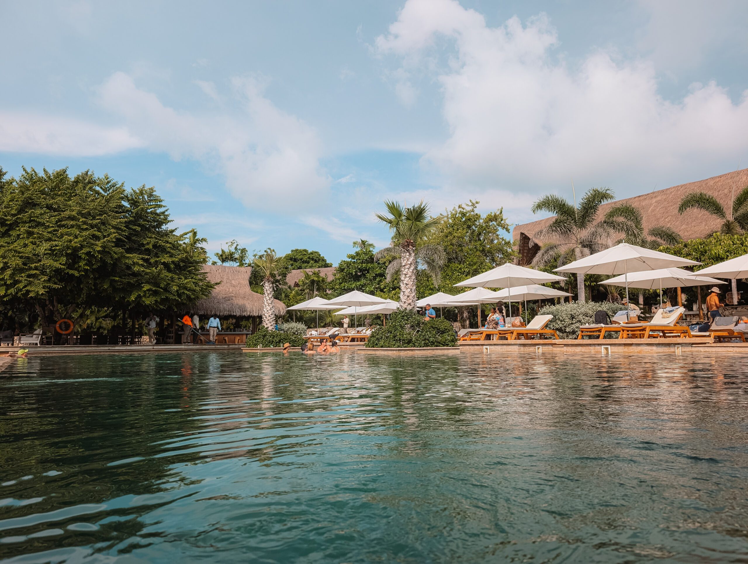 Lounge chairs and umbrellas around the pool area of Makani outside of Cartagena