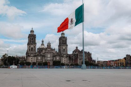 The Zocalo of Mexico City with a large Mexico flag pole in the middle