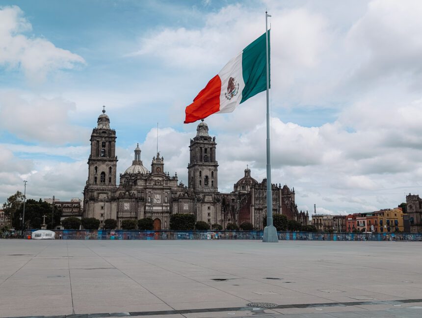 The Zocalo of Mexico City with a large Mexico flag pole in the middle