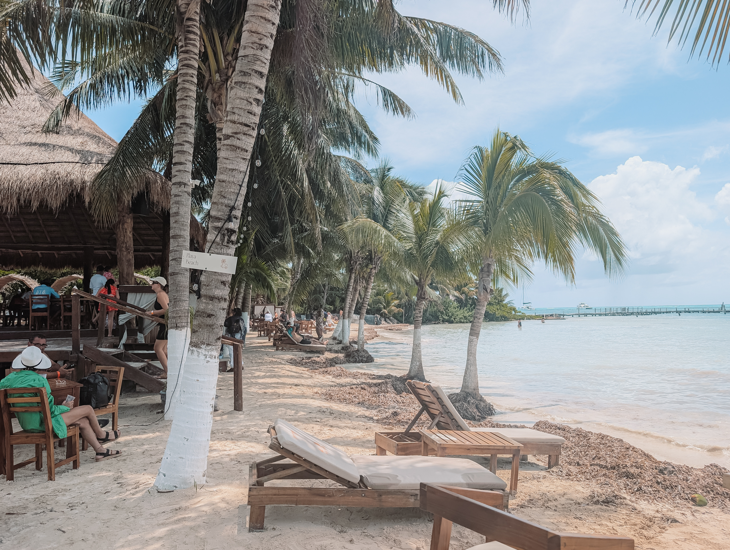Lounge chairs and areas along a tropical white sand beach in Cancun